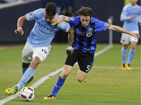 Impact's Maxim Tissot, right, defends New York City FC's Khiry Shelton during the first half of an MLS soccer game, Wednesday, April 27, 2016, at Yankee Stadium in New York.