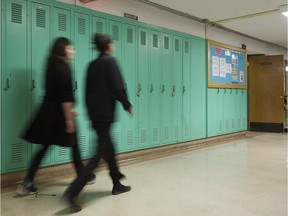 Students walk by lockers at Lakeside Academy school in Lachine.