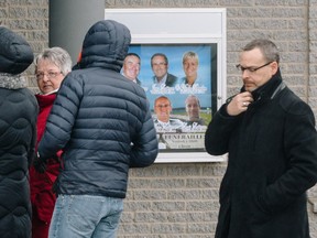 People line up to pay their respects to the Lapierre family during the public visitation at a funeral home in les Îles-de-la-Madeleine on Thursday, April 7, 2016.