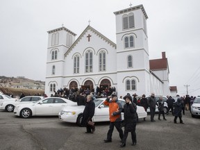 Mourners exit the funeral of the six Lapierre family members at the Saint-Francois-Xavier church in Les Iles-de-la-Madeleine on Friday, April 8, 2016.