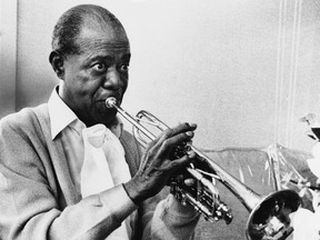 In this June 21,1971, photo, Louis Armstrong practises with his horn at his Corona, New York home.