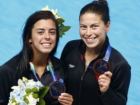 Canada's silver medalists Meaghan Benfeito and Roseline Filion pose after the medal ceremony for women's synchronised 10m platform diving final at the Swimming World Championships in Kazan, Russia, Monday, July 27, 2015.