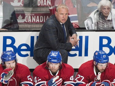 Montreal Canadiens head coach Michel Therrien looks on from the bench during first period NHL hockey action against the Tampa Bay Lightning in Montreal, Saturday, April 9, 2016.