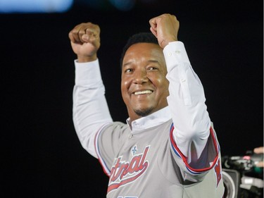 Former Montreal Expos player Pedro Martinez gestures at the crowd as he is introduced before the exhibition match between the Toronto Blue Jays and the Boston Red Sox at the Olympic Stadium in Montreal on Friday, April 1, 2016.