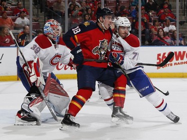 Goaltender Mike Condon defends the net as Joel Hanley of the Montreal Canadiens checks Reilly Smith of the Florida Panthers away from the crease during first period action at the BB&T Center on April 2, 2016, in Sunrise, Fla.