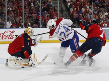 Goaltender Roberto Luongo defends the net as Dmitry Kulikov of the Florida Panthers ties up Phillip Danault of the Montreal Canadiens during second period action at the BB&T Center on April 2, 2016, in Sunrise, Fla.