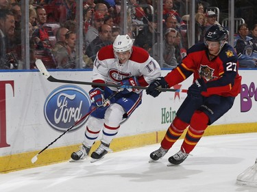 Nick Bjugstad of the Florida Panthers checks Torrey Mitchell of the Montreal Canadiens off the puck behind the net during second period action at the BB&T Center on April 2, 2016, in Sunrise, Fla.