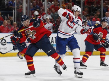 Max Pacioretty of the Montreal Canadiens and Rocco Grimaldi of the Florida Panthers come together at mid ice during second period action at the BB&T Center on April 2, 2016, in Sunrise, Fla.