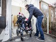 Richard Côté, right, pushes his daughter Ava Rose Côté into the exterior elevator of their house on Sunday, April 3, 2016, in Pierrefonds. She was born with brain damage and cerebral palsy. She attends the MacKay Centre, which means getting her wheelchair from the house to the van five times a week all year long. The ramp is fine in good weather, but snow causes problems. Various company came together and gave materials and expertise for free, to build her an exterior elevator which allows her to access the van in all types of weather. (Giovanni Capriotti / MONTREAL GAZETTE)