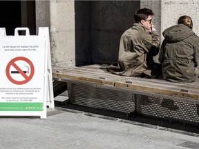 Student Tim MacLean, left, smokes at the entrance of the McGill University Redpath tunnel on Tuesday April 5, 2016, in Montreal.