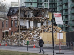 The site of the demolition of a housing cooperative in the Griffintown area of Montreal Tuesday, April 12, 2016. Residents are homeless and still in shock after they were ordered out of their homes Saturday because of shifting ground. One of the buildings had to be demolished Sunday because firefighters feared it could collapse.