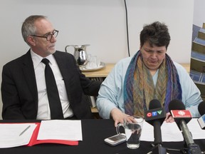 Guylaine Mayer, president of the Coopérative Ste-Anne is overcome with emotion and receives support from Marcel Pedneault, executive director of the Fédération des coopératives d'habitation intermunicipale du Montréal métropolitain (FECHIMM), at a press conference in Montreal Wednesday, April 13, 2016 a she recounted details of the sudden demolition of a Griffintown area heritage building  where her two sisters lived.