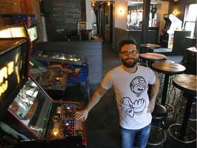 Dominic Bourret, founder of Arcade MTL, poses on his new arcade bar on St-Denis St. Dominic tried to open an arcade bar last fall but the city wouldn't let him. Soon after, he got the right permit and last week his Arcade opened.