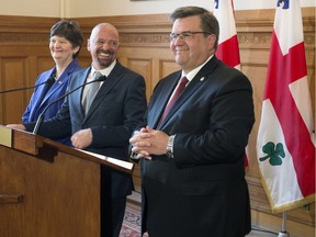 Serge Lareault, centre, at a press conference with Montreal Mayor Denis Coderre, right, and executive committee member Monique Vallée. Lareault was introduced as the city's homeless protector.