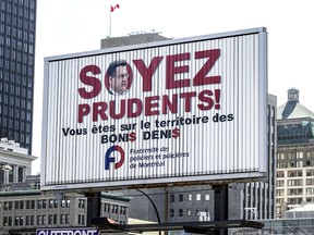 Billboard on Viger St. in Montreal, Wednesday April 20, 2016 put up by Montreal's police union accusing Mayor Denis Coderre of enacting a quota for traffic tickets for police to fulfill.
