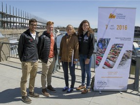 Triathletes, from left, Xavier Grenier-Talavera, Jeremy Obrand, Emy Legault and Elisabeth Boutin pose for photographs in Montreal's Old Port, on April 20, 2016, after an anouncement that the Montreal International Triathlon will be held in the city on Aug. 7, 2016.