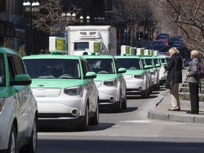 A Téo Taxi e-vehicle fleet drives down McGill College Ave. in 2016 to launch the company's spring season.