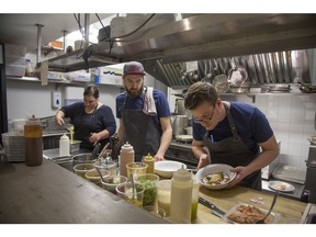 At La Petite Maison on Parc Ave., chef/owner Danny St-Pierre, right, prepares his simplest menu to date with help from Karine St-Pierre and Mathieu Collins.
