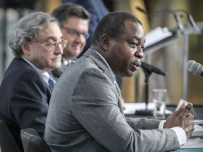 Michael Sabia, left, president and CEO of the Caisse de dépôt et placement du Québec, and Montreal Mayor Denis Coderre listen as Macky Tall, president and CEO of CDPQ Infra, answers a question at the press conference at the Caisse's headquarters in Montreal Friday April 22, 2016.