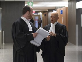 Paul Skolnik (right), lawyer for Georgi Sptizer, talks with prosecutor Jean-Christofe Ardeneus, during a break in proceedings at Spitzer's fraud trial at the Montreal courthouse Tuesday, April 26, 2016.