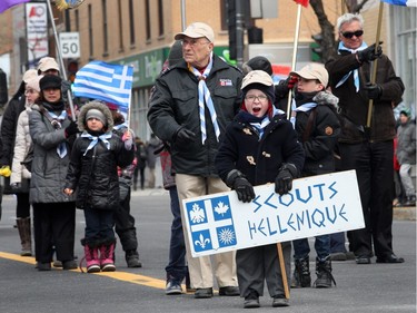 A little boy from the Hellenic Scouting Group yawns while waiting for their turn to walk in the parade during the Greek Independence Day parade on a cold and windy Sunday, April 3, 2016, on Jean-Talon Blvd. in Montreal.