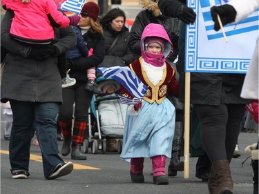 Participants braved the cold by wearing winter clothes underneath their costumes during the annual Greek independence Day parade on Sunday, April 3, 2016, in Montreal.