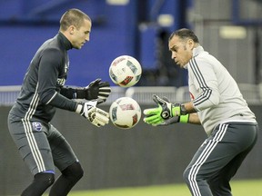 Impact goalkeeper Evan Bush, left, juggles soccer balls with coach Youssef Dahha during team's practice at the Olympic Stadium in Montreal Friday April 8, 2016.