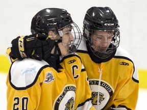On Monday, Lac St-Louis Lions forward Mathias Laferriere (right, with teammate Adam Capannelli) scored the winning goal with 37 seconds left in the third period during the team's first game at the Telus Cup, the midget AAA national championship.