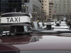 Taxi drivers staged a protest against Uber  outside Premier Philippe Couillard's office in downtown Montreal on Friday April 8, 2016.