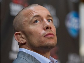 Georges St-Pierre listens to questions during an UFC press conference with Georges St-Pierre and Johny Hendricks to promote UFC 167, in Montreal on Thursday August 1, 2013.