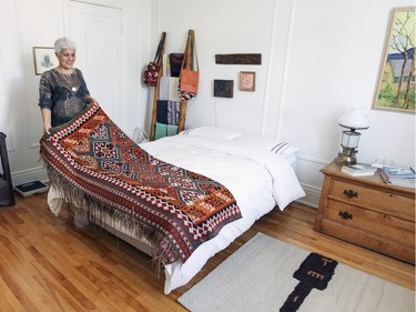 Mahin Shafei shows her family kilim, a rug that, per Iranian custom, is given as a gift when one leaves their parents' home.   (John Mahoney / MONTREAL GAZETTE)