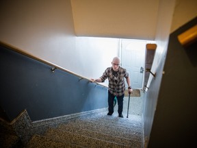 Twenty-six year-old geological engineer Justin Roy Dupuy, who had his right leg amputated above the knee in his ongoing battle with cancer, walks up the stairs of his apartment building at his home in Montreal on Wednesday, January 6, 2016.