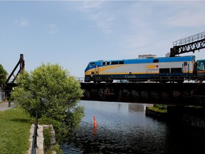 MONTREAL, QUE.: JULY 8, 2015-- A VIA Rail train crosses the Lachine Canal in front of the Tour d‚Äôaiguillage Wellington in Montreal on Wednesday July 8, 2015. (Allen McInnis / MONTREAL GAZETTE)