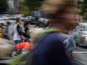 Pedestrians cross Ste-Catherine St. on the corner of Metcalfe St. in Montreal on Wednesday, June 10, 2015.