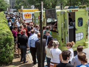 Montrealers line up for fast food from mobile trucks at Cathedral St. and René-Levesque Blvd. in Montreal, on Thursday, June 27, 2013.