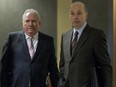 Former Union Montreal fundraiser Bernard Trépanier, left, and former Montreal executive committee chairman Frank Zampino wait to enter a courtroom at the Montreal courthouse, Tuesday March 22, 2016, for the resumption of the Contrecoeur trial.