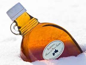A bottle of freshly poured maple syrup.