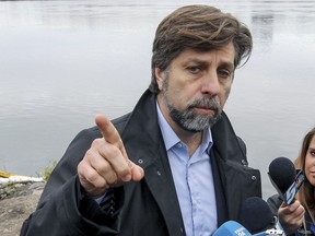 Plateau Mont-Royal borough mayor and Projet Montreal leader Luc Ferrandez holds a press conference by the St. Lawrence River in Montreal Wednesday November 11, 2015, on the first day of dumping of raw sewage into the river to allow repairs to a sewage collector and construction of a new snow chute.