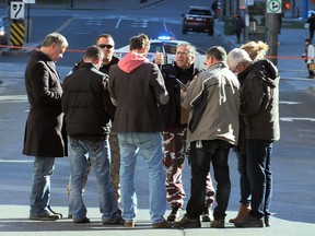 Police investigators in civilian clothing gather on St. Urbain St. near the scene of a stabbing in Chinatown in November. The number of violent incidents increased in 2015, statistics released by the Montreal police force reveal.