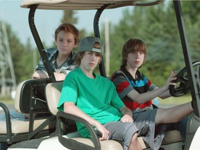 Nate (Nick Serino), at the wheel, Riley (Reece Moffett) in the passenger seat, and Adam (Jackson Martin) in the back are shown in a scene from the film  Sleeping Giant, by  Andrew Cividino.