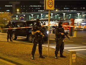 Dutch policemen stand guard by a cordoned off area outside Amsterdam's Schiphol Airport late on April 12, 2016, after it was partially evacuated following a security alert, and a person was arrested, according to official sources.