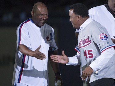 Former Montreal Expos pitcher Pedro Martinez, right, and outfielder Tim Raines shake hands as they are honoured in a pre-game ceremony before the Toronto Blue Jays take on the Boston Red Sox in spring training baseball action Friday, April 1, 2016, in Montreal.