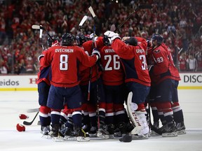 T.J. Oshie (#77) of the Washington Capitals is mobbed by teammates after scoring the game-winning goal to give the Capitals a 4-3 overtime win over the Pittsburgh Penguins in Game One of the Eastern Conference Second Round during the 2016 NHL Stanley Cup Playoffs at Verizon Center on April 28, 2016 in Washington, DC.