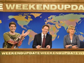 In this May 18, 2013, photo released by NBC, from left, Bill Hader, Seth Meyers, Amy Poehler appear in the Weekend Update skit on an episode of Saturday Night Live.