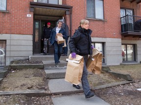 Montreal police investigators leave an apartment building on Davidson St. in Hochelaga-Maisonneuve district, Montreal, Wednesday  April 13, 2016, with evidence, after the arrest of the suspect in the stabbing death of Maxi employee, 20-year-old Clémence Beaulieu-Patry.  The 19-year-old man has been charged with first degree murder.  (Phil Carpenter/MONTREAL GAZETTE)