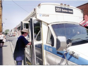 A passenger boards on the new mini-buses in Ste-Anne-de-Bellevue back in 1997, when they were first introduced. (Gazette file photo)