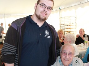 The Annual Spring Luncheon is a must on the social calendar for hundreds of seniors in Pointe-Claire. It's a chance for younger and older generations to mingle over a nice lunch and glass of wine. Pictured are volunteer and student Nick Gosselin and luncheon guest Mr. Strati. Photo is courtesy of the City of Pointe-Claire.