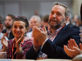 NDP Leader Thomas Mulcair, right, and his wife, Catherine Pinhas, left, take part during the 2016 NDP Federal Convention in Edmonton on Friday, April 8, 2016.