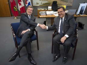 Toronto Mayor John Tory (left) laughs with Montreal Mayor Denis Coderre prior to their press conference at Toronto city hall, Wednesday March 25, 2015.