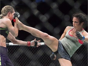 Montrealer Valérie Létourneau, right, lands a kick to the head of Jessica Rakoczy during their UFC 186 fight in Montrealon April 25, 2015.